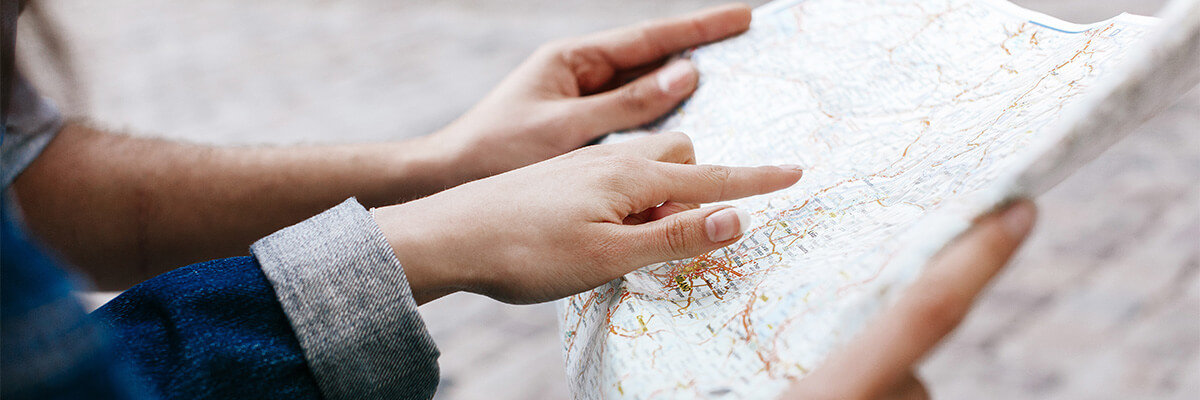 Hands pointing at map.
